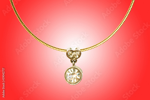 Golden jewellery against gradient background