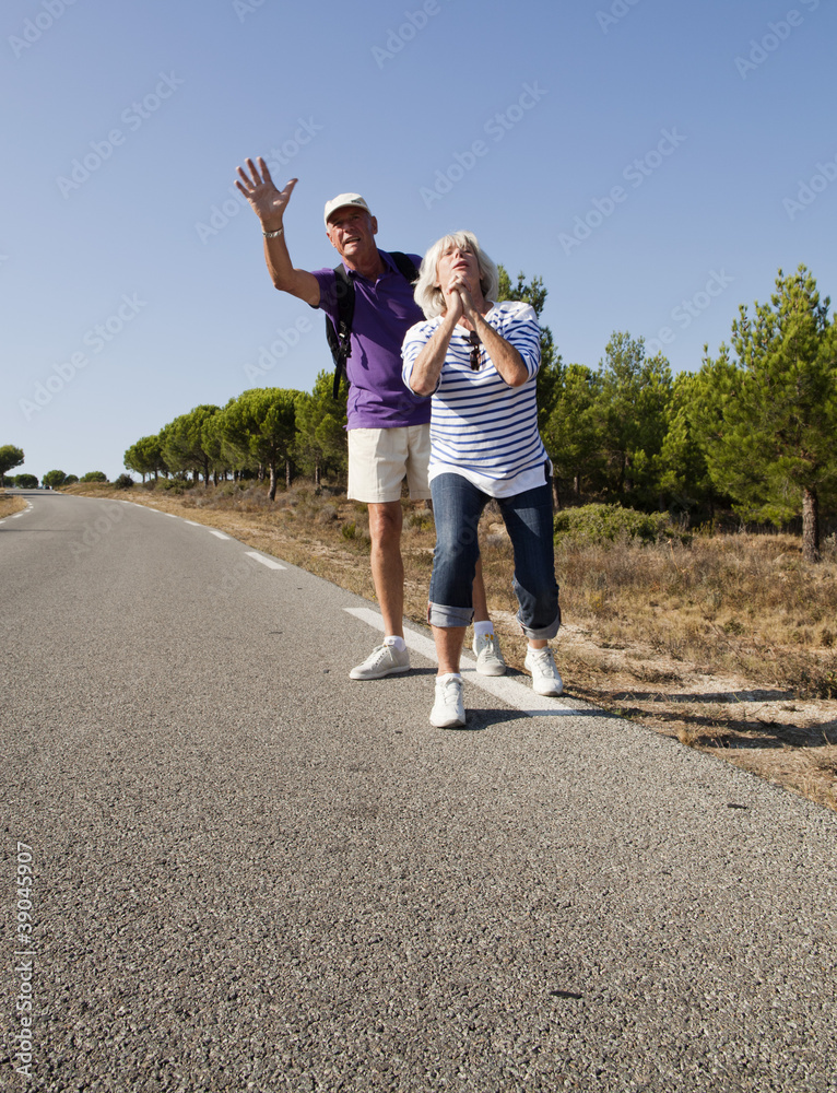 Fototapeta premium senior hitchhikers begging for assistance
