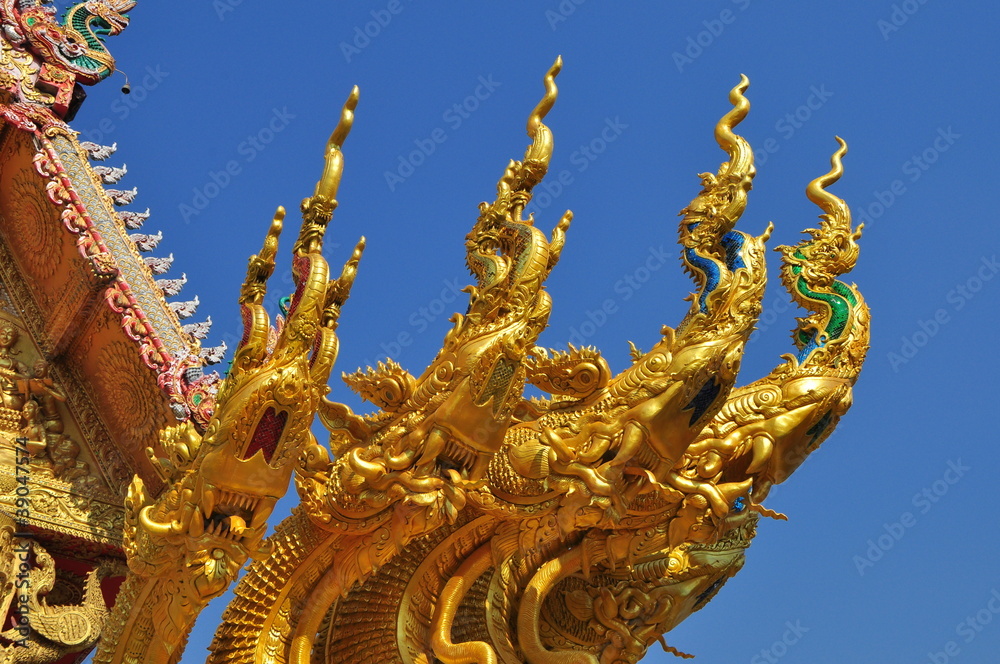 Fototapeta premium four heads of golden serpent sculpture