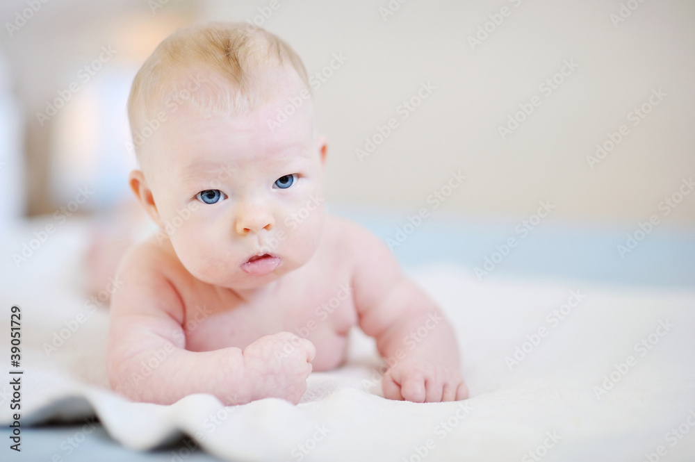 Adorable baby girl on a white blanket Adorable baby girl on a white blanket