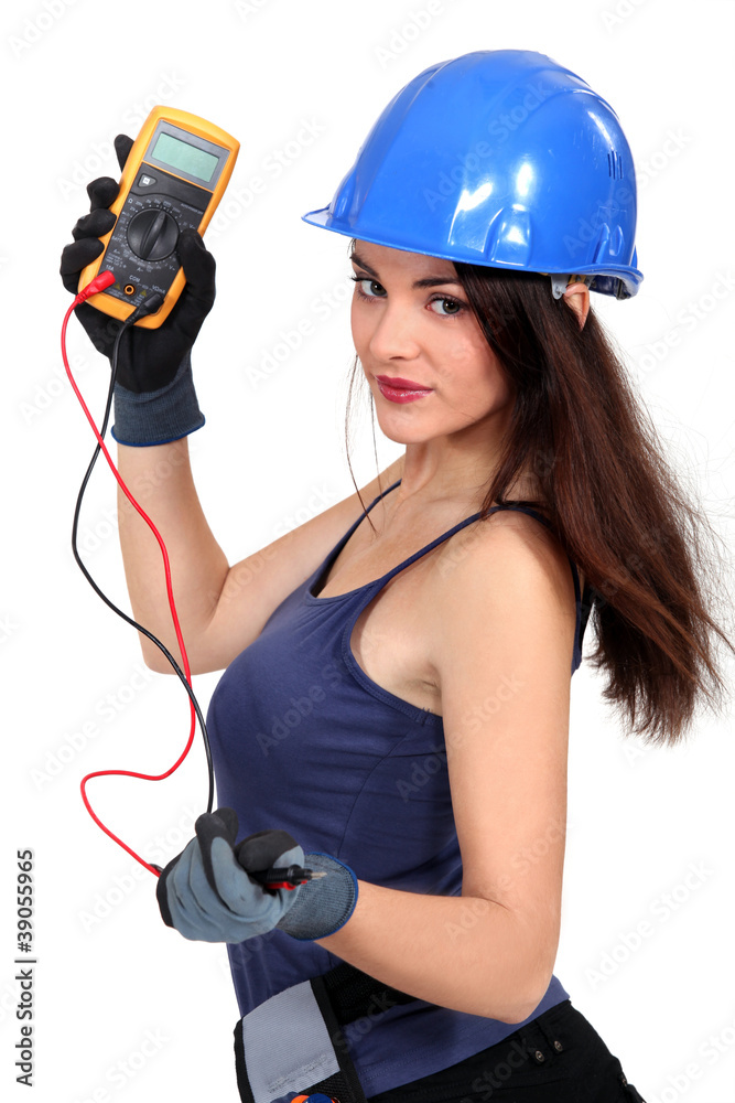 Sexy tradeswoman holding a multimeter Sexy tradeswoman holding a multimeter