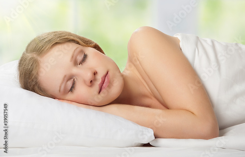 beautiful young woman sleeping in bed