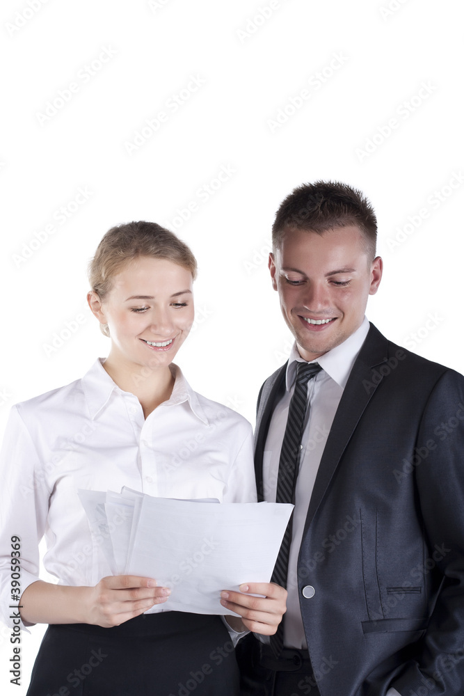 Two businesspeople sitting at table and writing Two businesspeople sitting at table and writing
