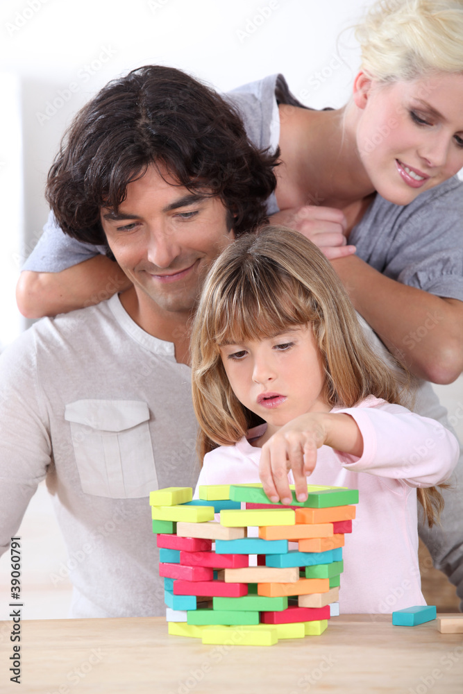 parents looking her daughter playing with blocks parents looking her daughter playing with blocks