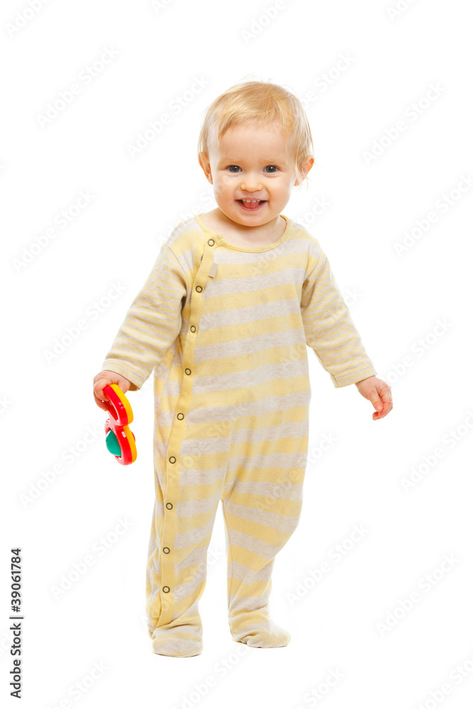 Smiling kid standing with rattle on white background Smiling kid standing with rattle on white background