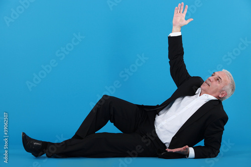 Photography A mature businessman lying on the floor.