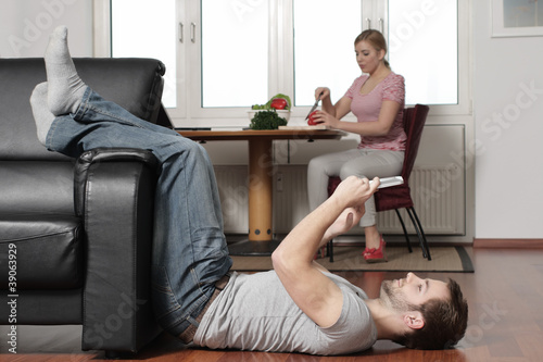 A young man plays with his Tablet PC at home