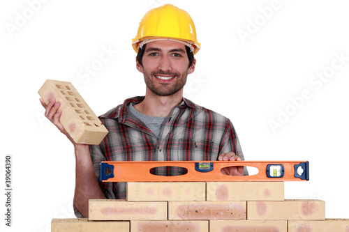 Bricklayer with a spirit level photo