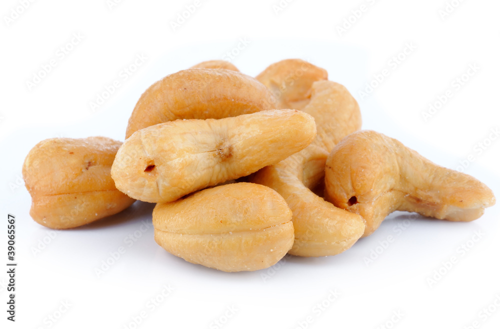 Pile of roasted cashew nuts in isolated white background
