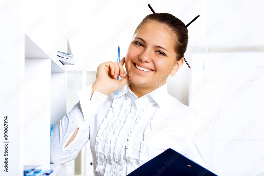 Young beautiful woman in business wear at work