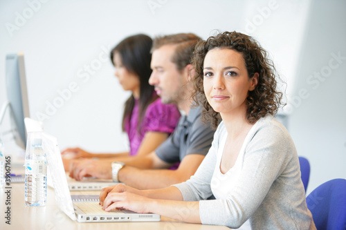 Fotografie three office workers sat in a row