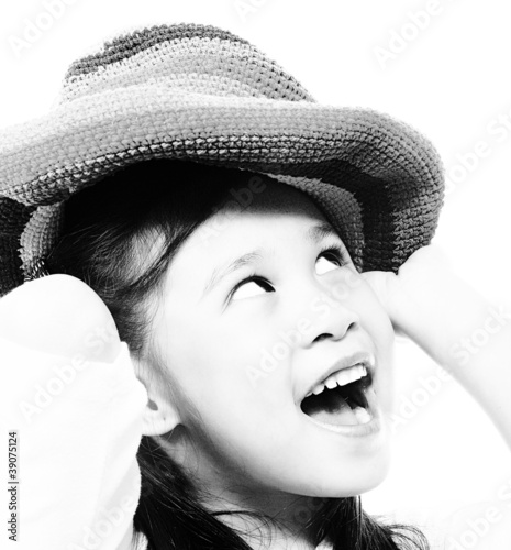 Smiling And Happy Girl Putting On A Hat