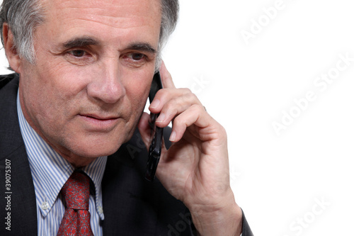 Older businessman with a cellphone