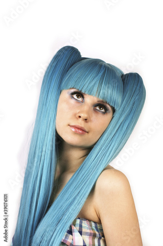 Portrait of young cute woman with blue hair looking up