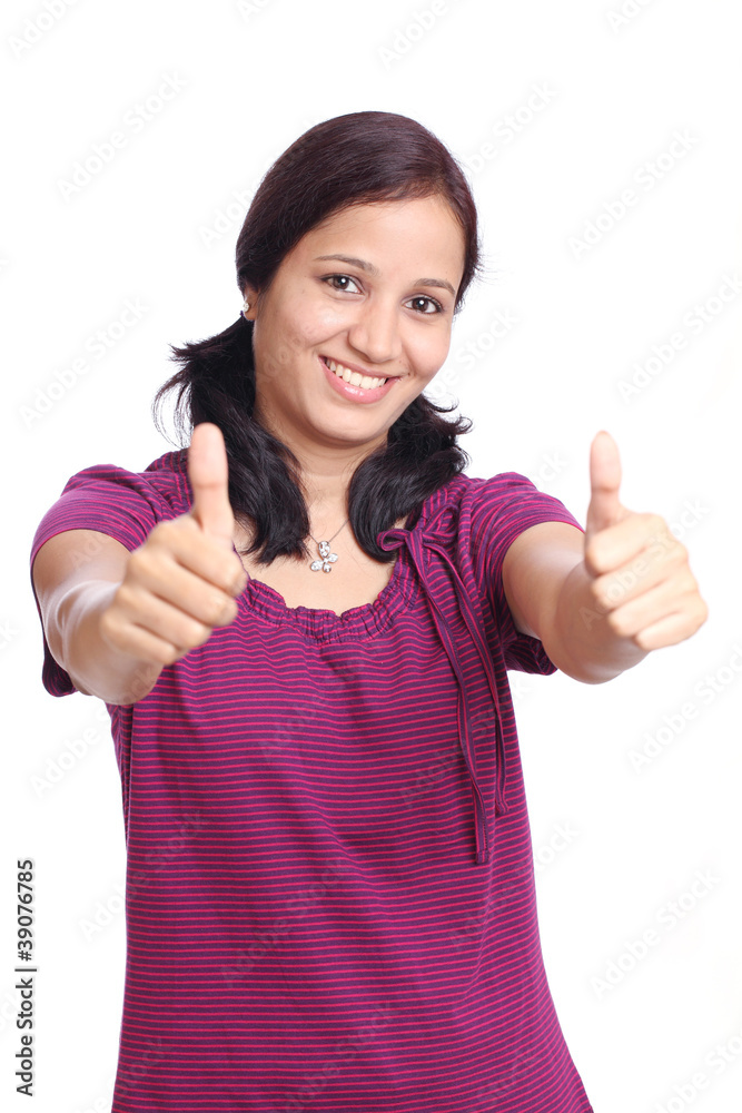 Smiling young Indian student showing thumbs up Smiling young Indian student showing thumbs up
