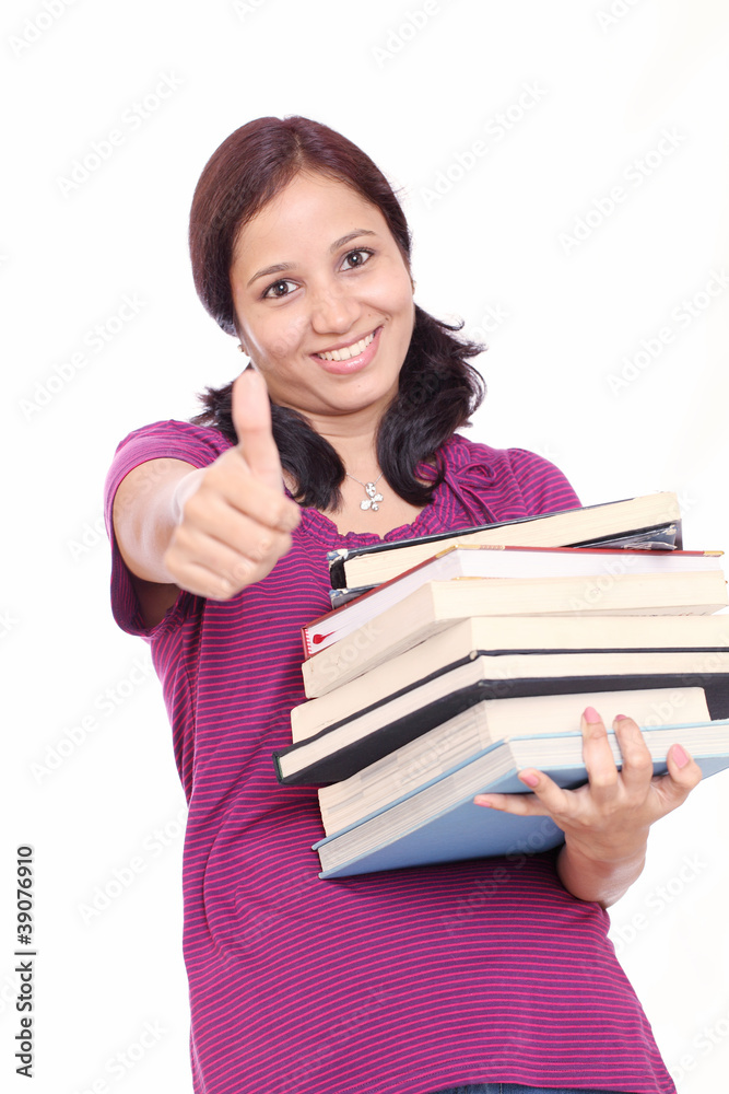 Successful female student giving thumb-up gesture Successful female student giving thumb-up gesture