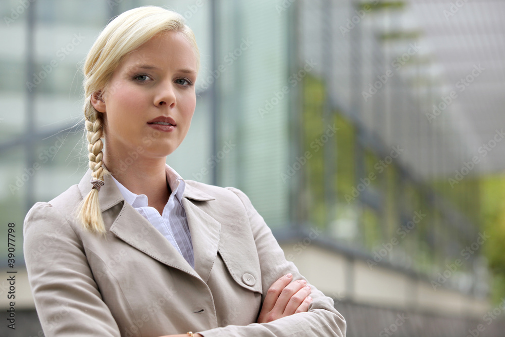 Blonde executive standing outside