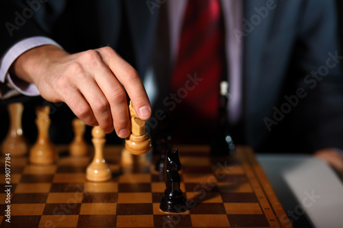 Businessman playing chess