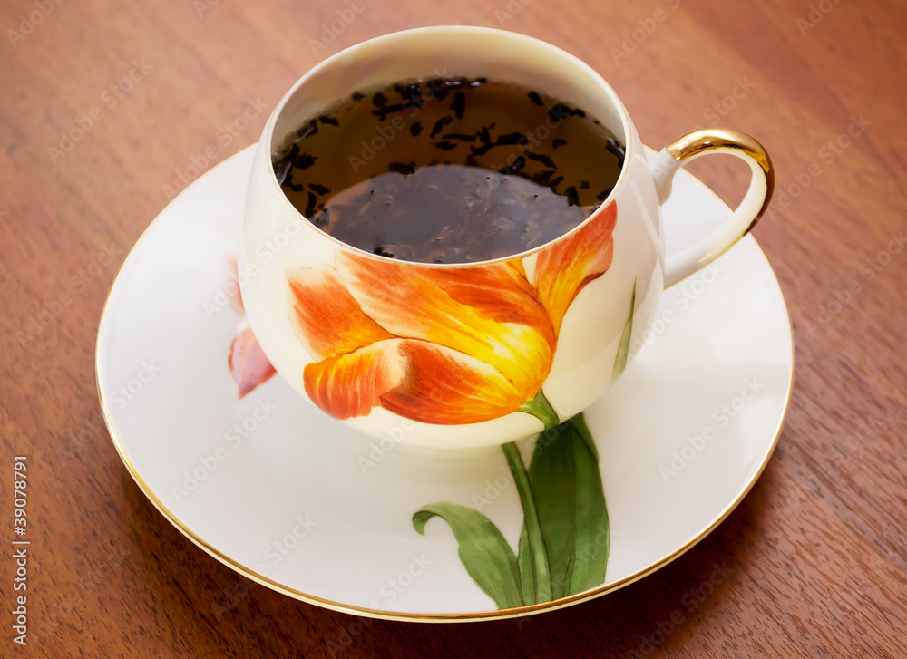 Obraz premium porcelain teacup and saucer on a wooden table
