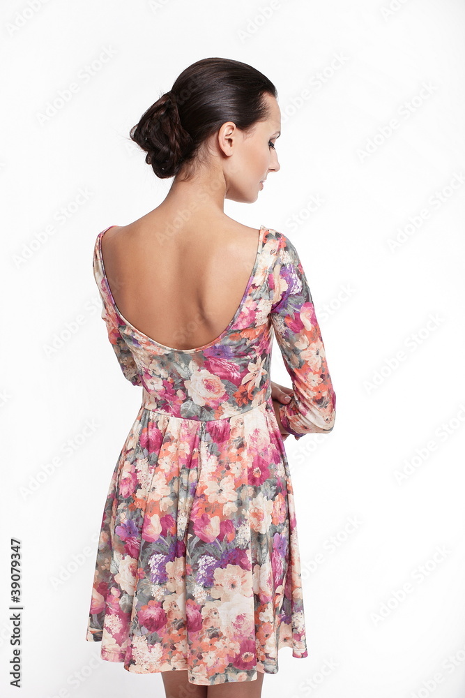 back of Young beautiful woman in colorful summer dress back of Young beautiful woman in colorful summer dress
