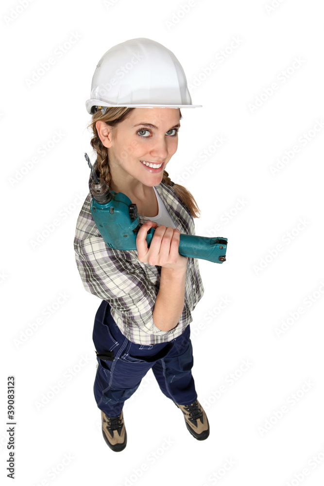 A female construction worker holding a drill. A female construction worker holding a drill.