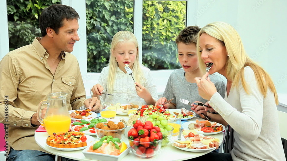 Young Caucasian Family Sharing Healthy Lunch Together Young Caucasian Family Sharing Healthy Lunch Together