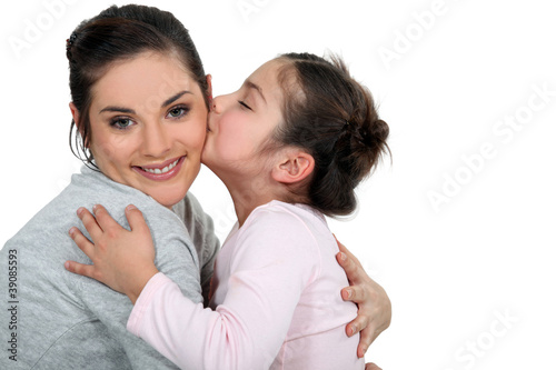 Daughter kissing her mum