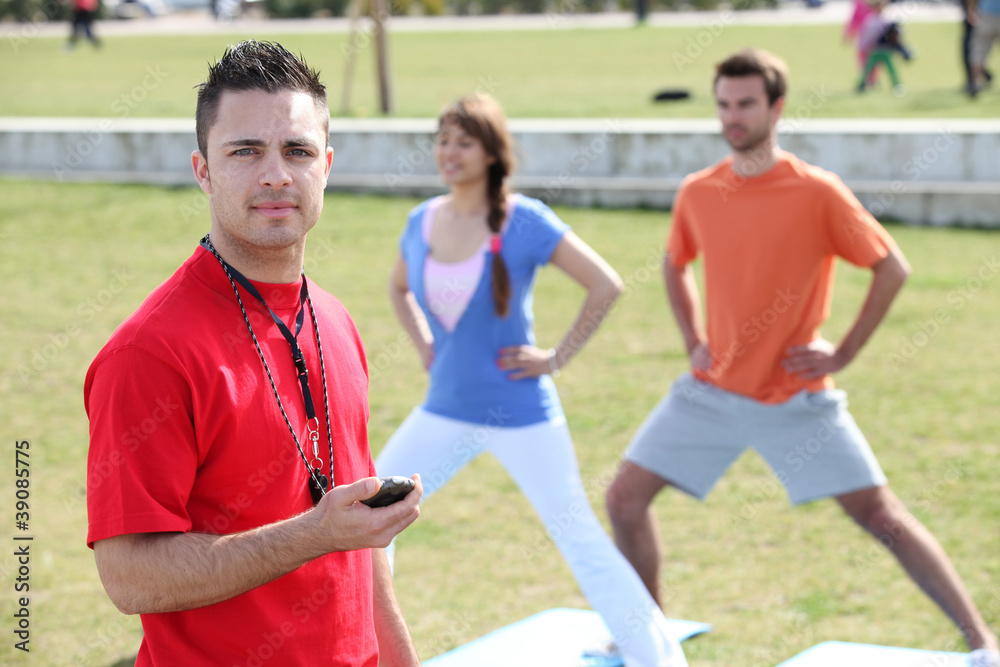Personal trainer with his clients Personal trainer with his clients