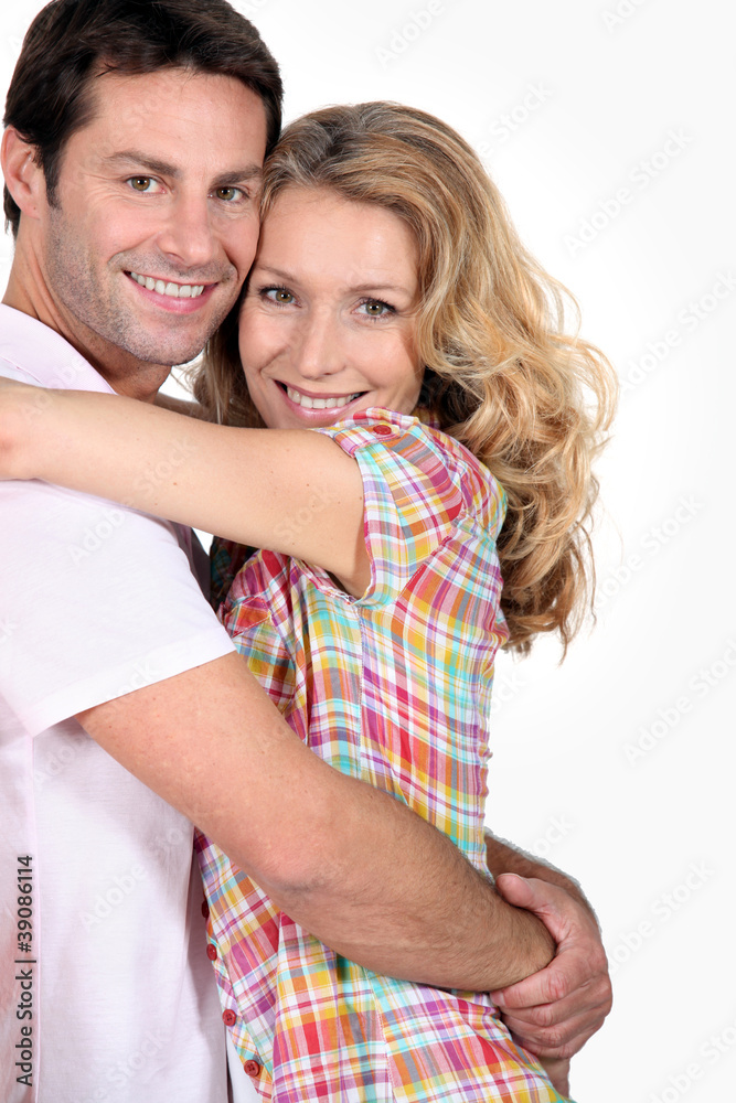 smiling couple hugging smiling couple hugging