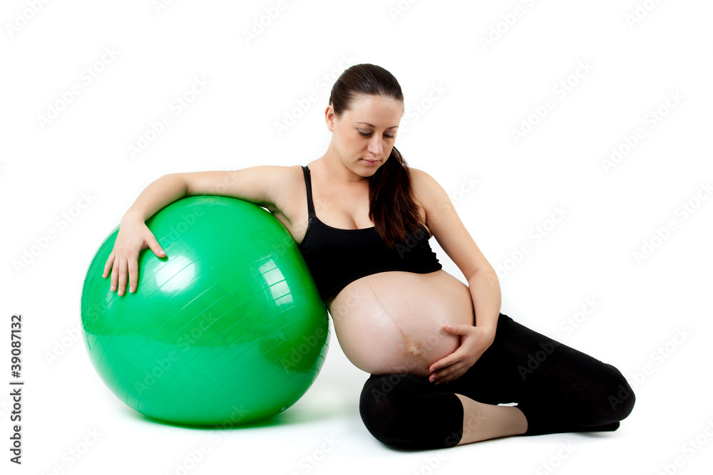 Pregnant woman excercises with gymnastic ball. Beautiful pregnan Pregnant woman excercises with gymnastic ball. Beautiful pregnan