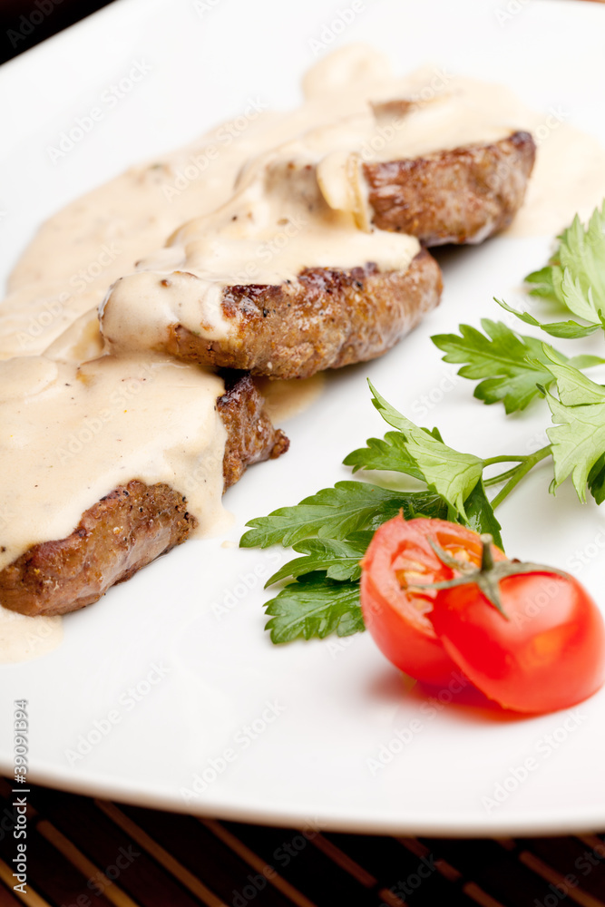 Roasted meat under white sauce