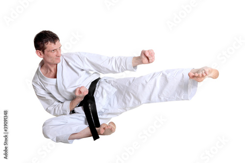 Karate jump against white background