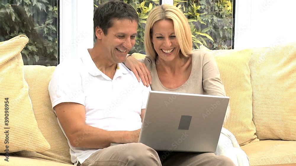 Caucasian Couple Using Home Laptop Caucasian Couple Using Home Laptop