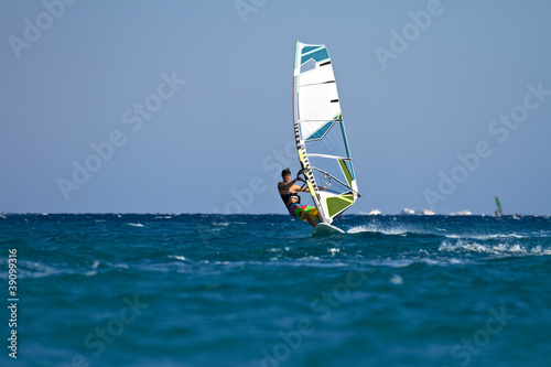 Young male windsurfer in action
