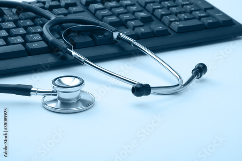 Stethoscope resting on a computer keyboard