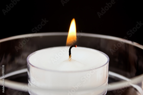 Burning tea candles in the dark