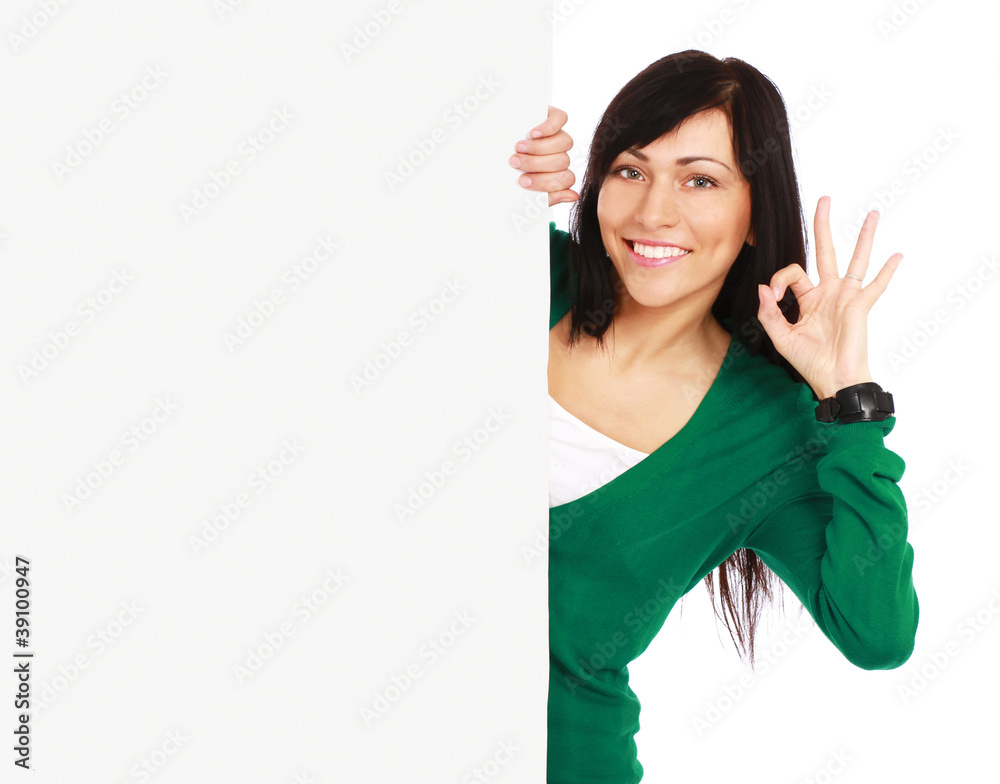 A smiling girl with a blank and showing ok A smiling girl with a blank and showing ok