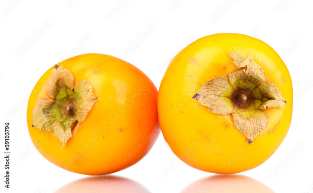 Two appetizing persimmons isolated on white