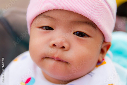 Asian baby bite her lip
