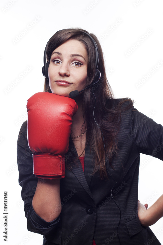 Businesswoman hitting herself with boxing gloves Businesswoman hitting herself with boxing gloves