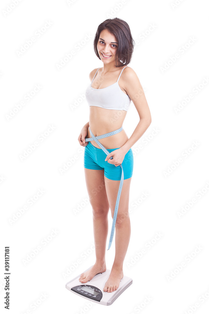 Fototapeta premium Young woman on a weighing machine