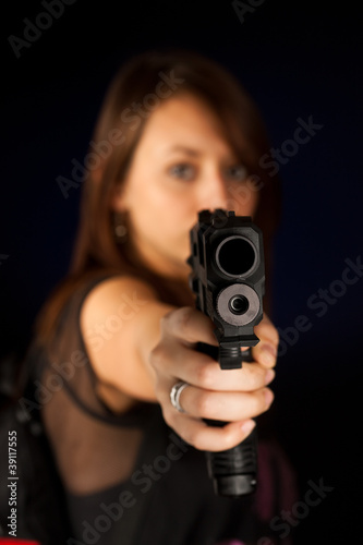 Sexy young woman with a gun