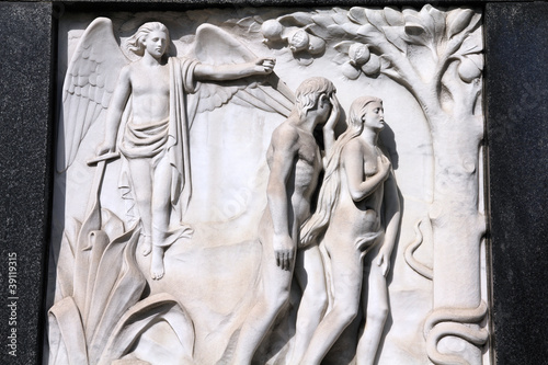 Adam and Eve - bas relief sculpture on a grave