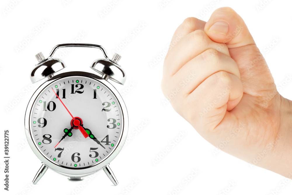 Alarm clock and a fist Alarm clock and a fist