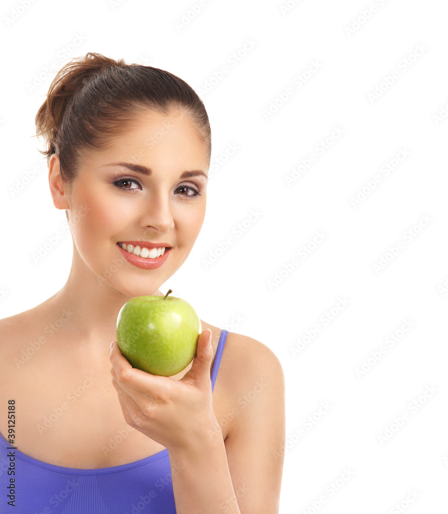 A young and fit brunette woman holding a fresh green apple A young and fit brunette woman holding a fresh green apple