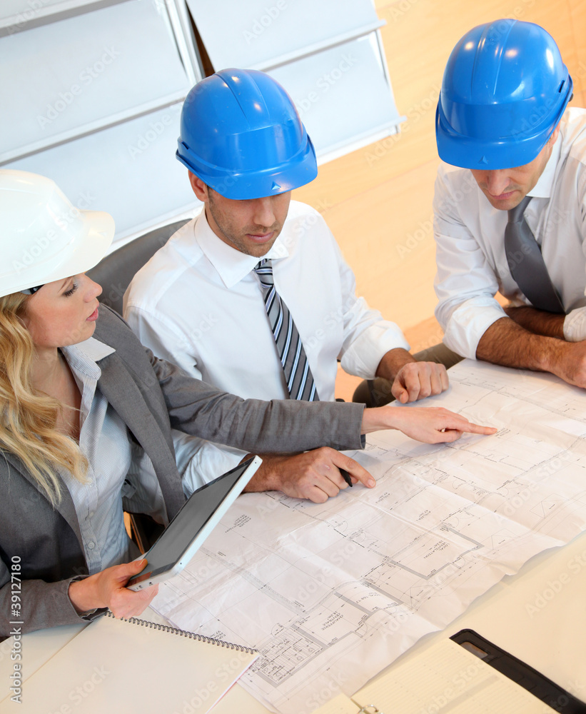 Architects and businesswomen working on construction project Architects and businesswomen working on construction project