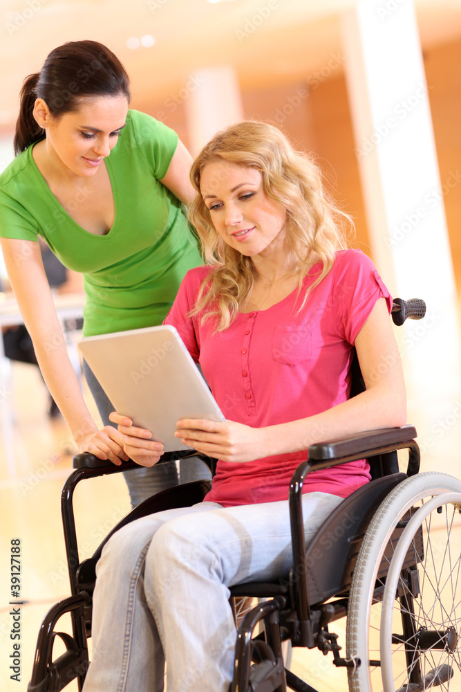 Handicapped person at work with electronic tablet