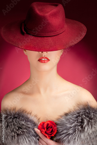 Portrait of stylish woman in hat with bright red lips