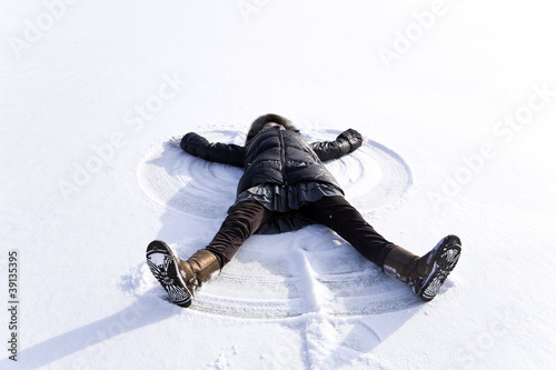 young woman kidding on snow in winter day