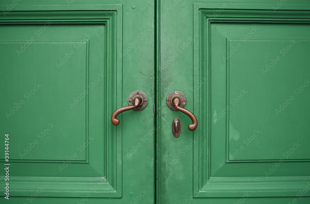 Door handles with an old double wood door Door handles with an old double wood door